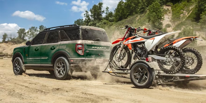 Green Ford Bronco Sport with Dirt Bikes on Trailer